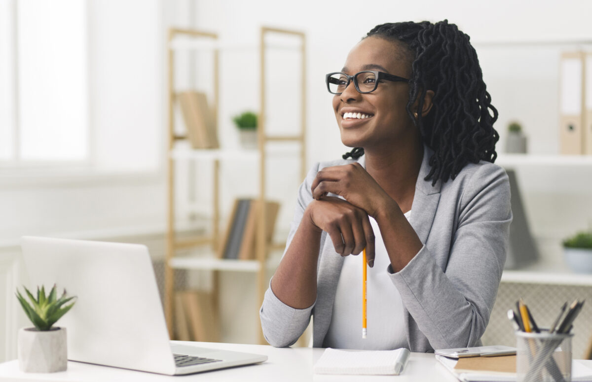 young afro business lady smiling sitting in modern office